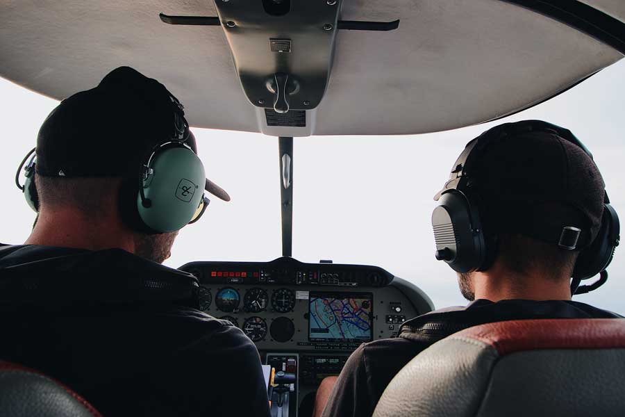 flight instructor teaching student while flying