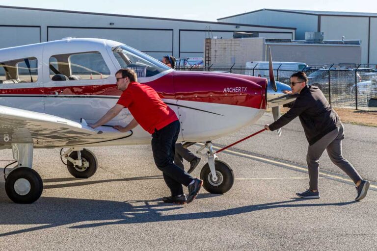 Instructor and student moving an aircraft