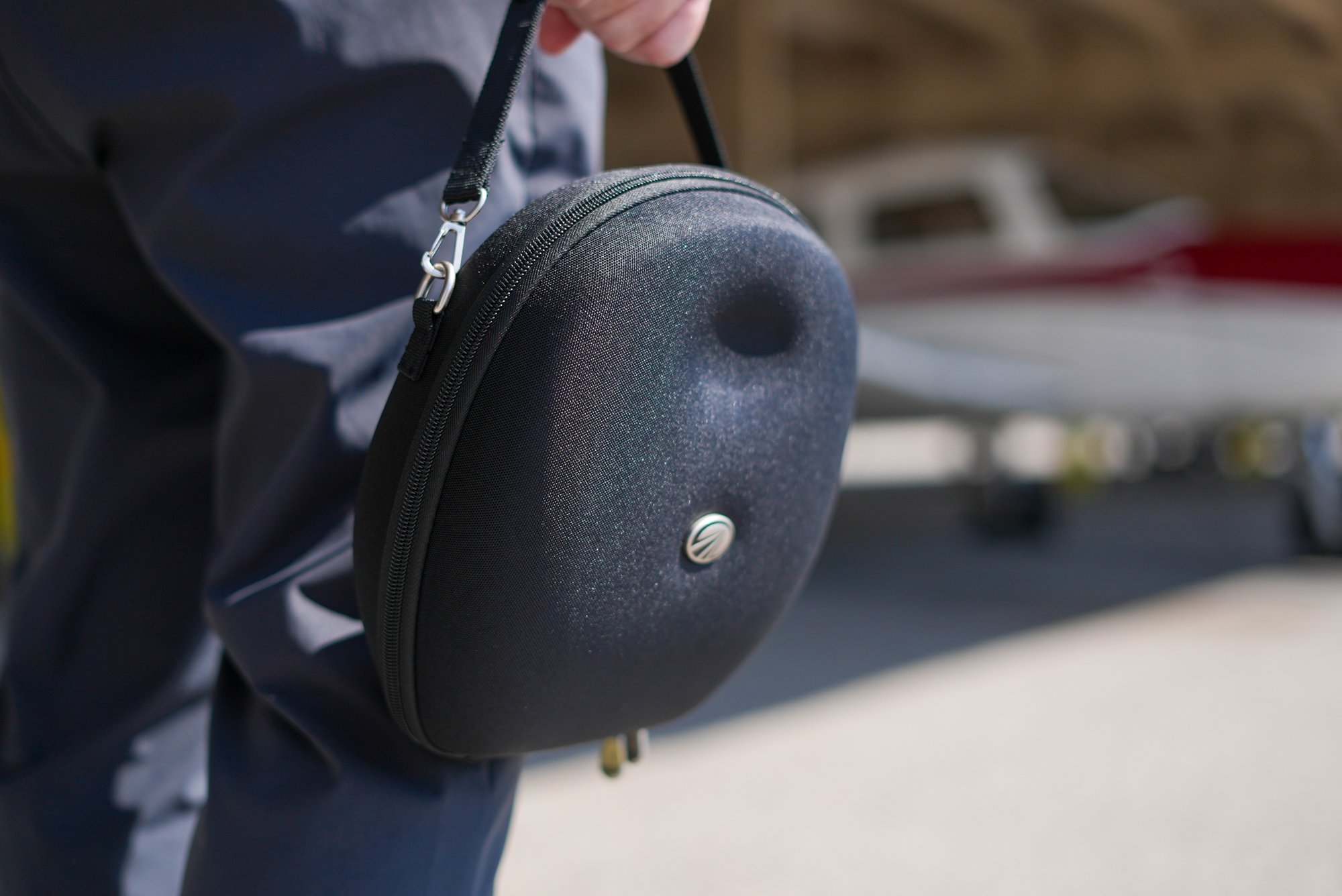 Thrust Flight student pilot carrying a Lightspeed Aviation headset case on the flight line